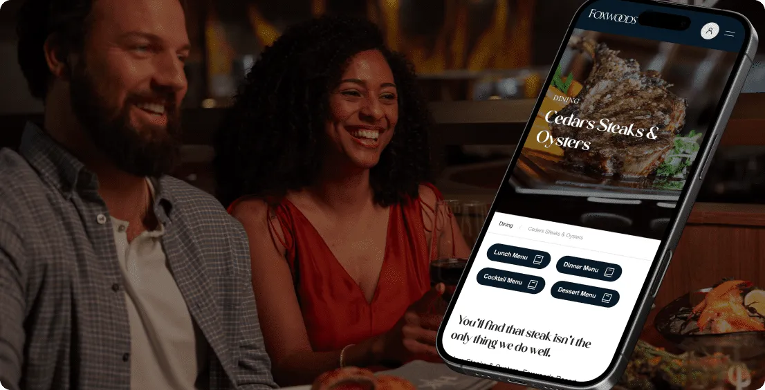 Foxwoods dining page for Cedars Steaks &amp; Oysters on a phone beside a smiling couple