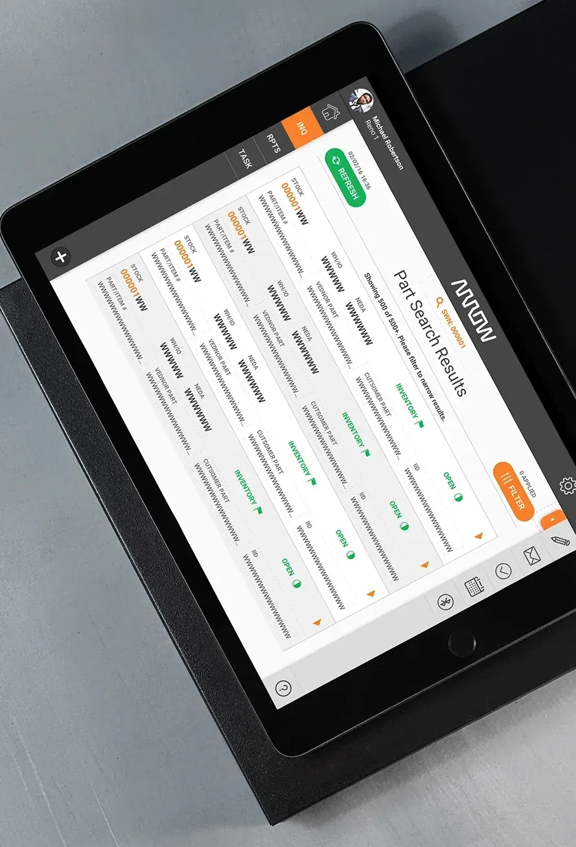 A tablet showing a part search results screen, with a grid of stock and part records and their inventory status.