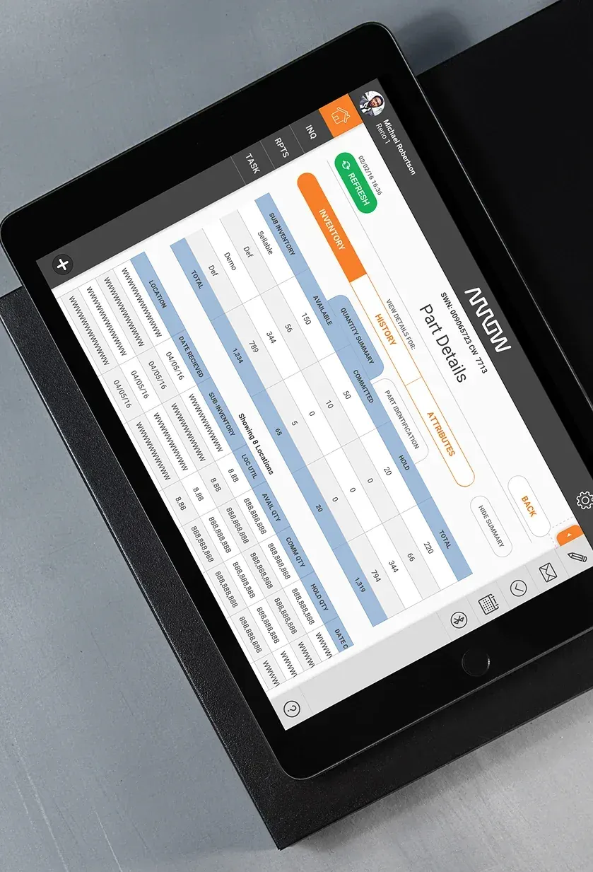 A tablet showing a part details screen, with inventory, history, and attribute tabs and a table of quantities by location.