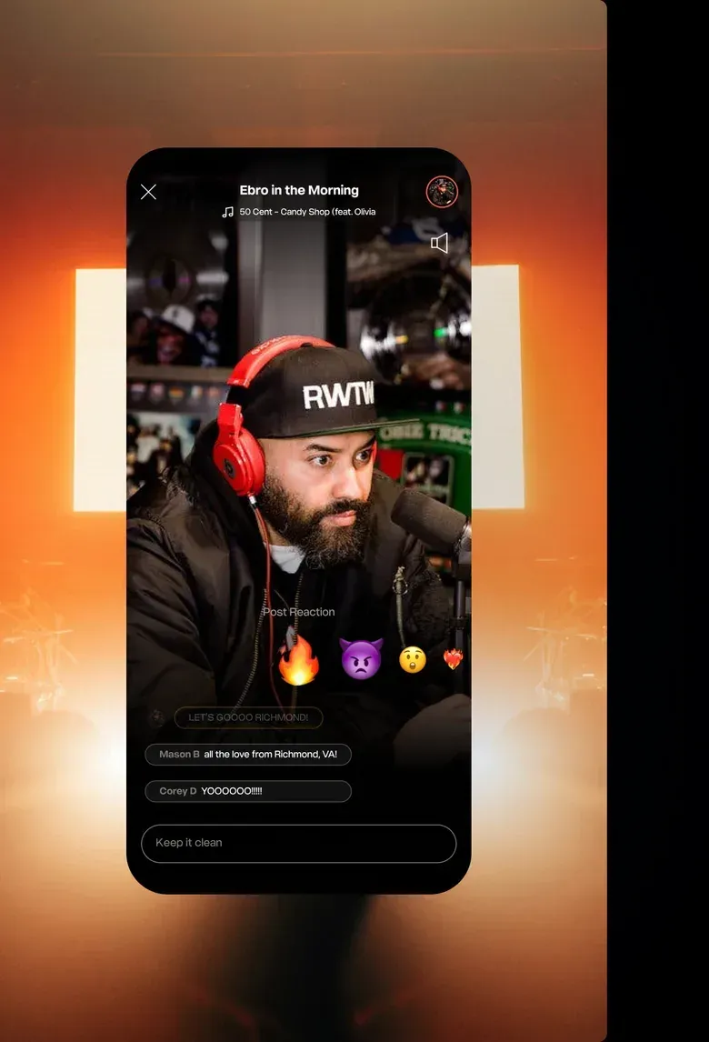 A Hot 97 live video screen with a DJ in the studio, emoji reactions and a chat box with two listener messages.