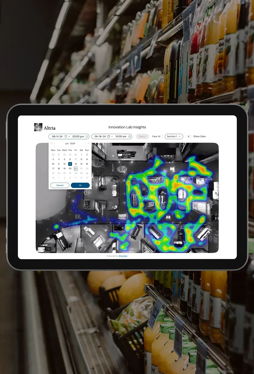 A tablet dashboard with a date picker and a heat map laid over a view of the lab.