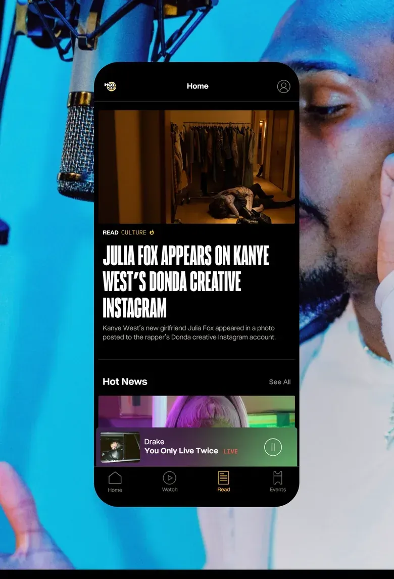 A Hot 97 Read screen with a featured news story and a Hot News list, over a photo of a performer in a recording studio.