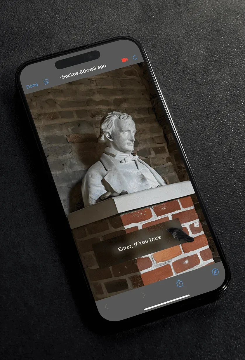 Poe's bust at the museum seen through a phone, with an Enter If You Dare prompt.