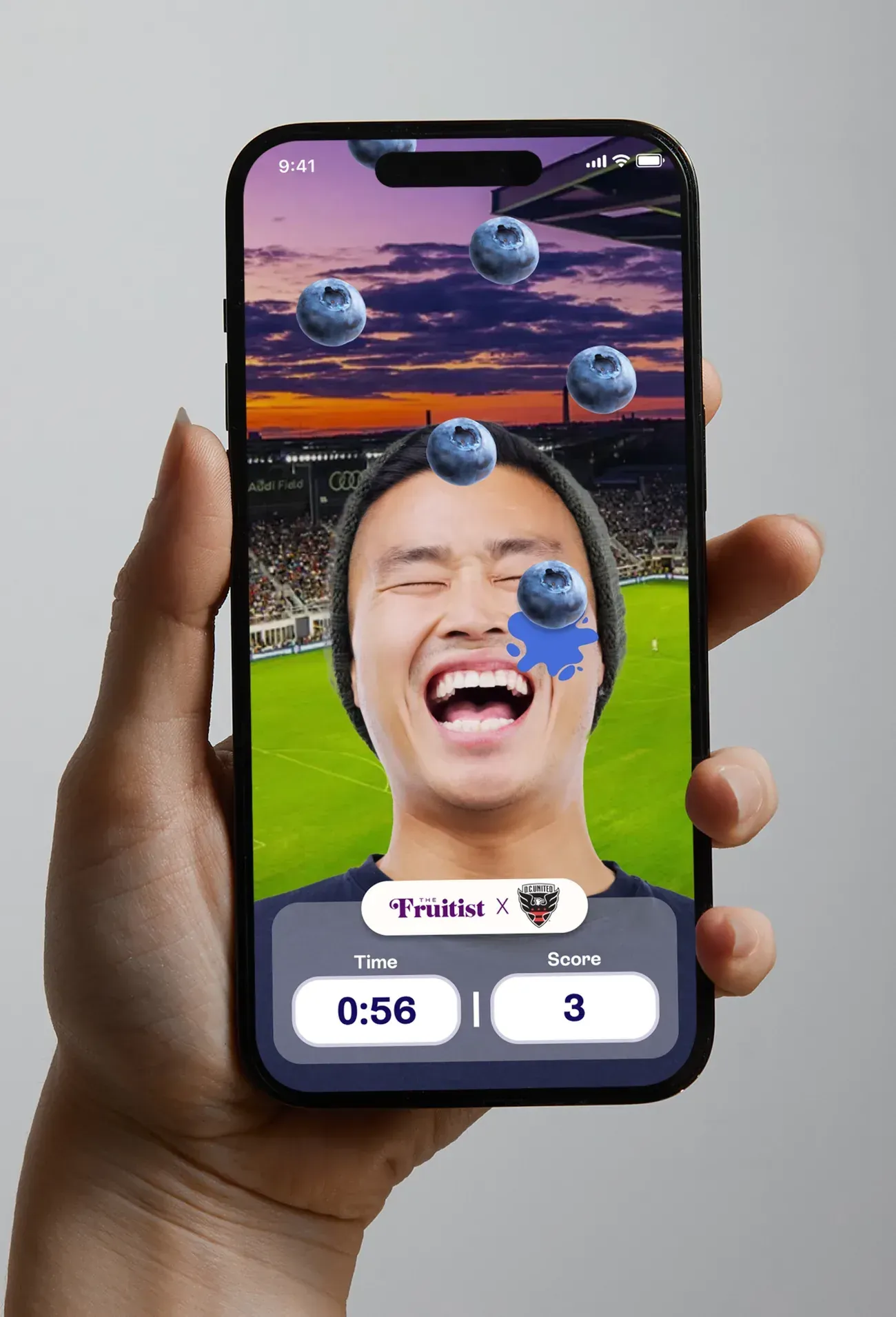A fan playing Blueberry Catch with the front camera, blueberries falling, and a timer and score below.