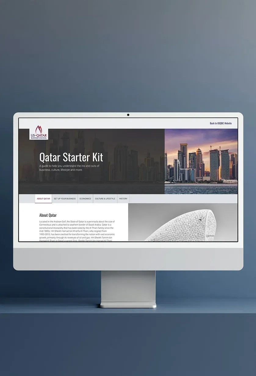 The Qatar Starter Kit page on a desktop monitor, with tabs for the country, setting up a business, the economy and culture.