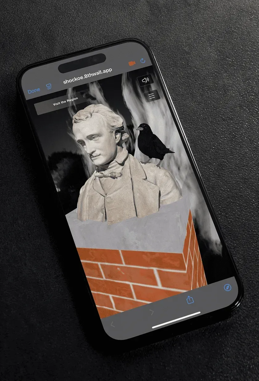 Poe's bust and raven rising above a brick pedestal in the augmented reality view.
