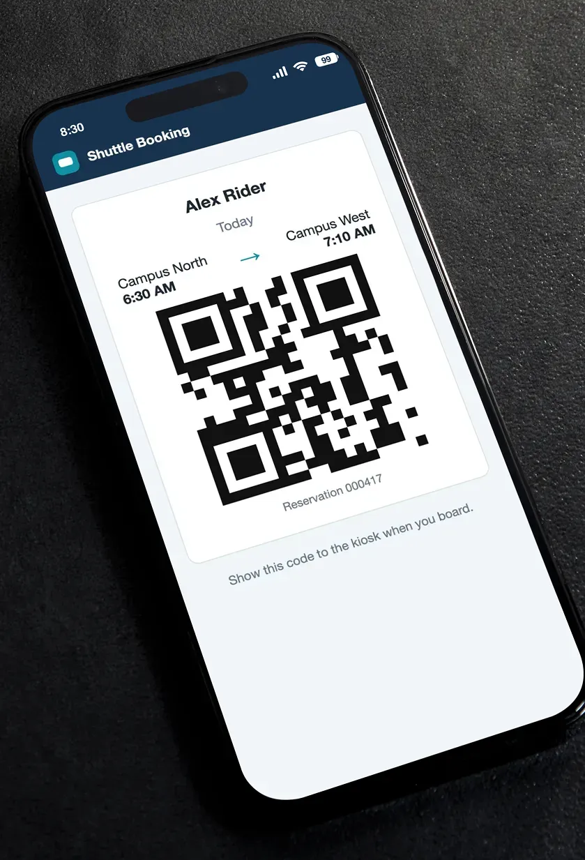 A phone showing a rider's QR ticket with the route, departure time and a reservation number.