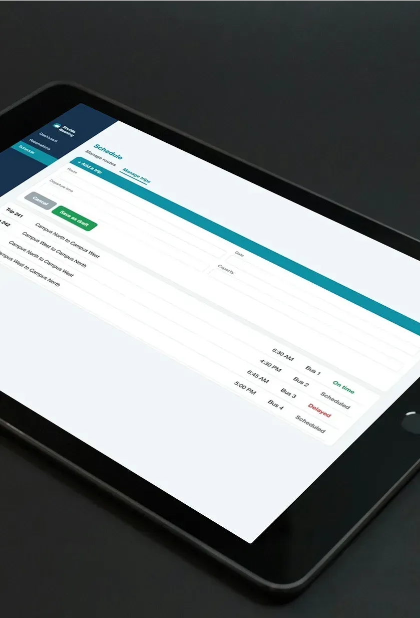 A tablet showing the schedule screen where operations add a trip and review each trip's bus and status.