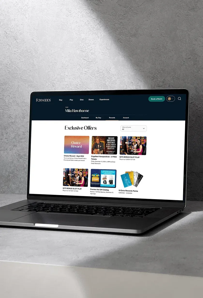 The website's exclusive offers page, shown on a laptop.