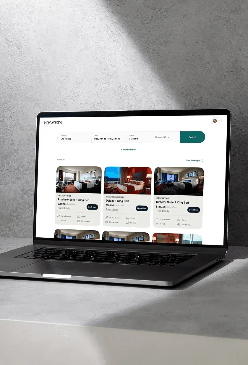 The website's room results page with photos and rates, shown on a laptop.
