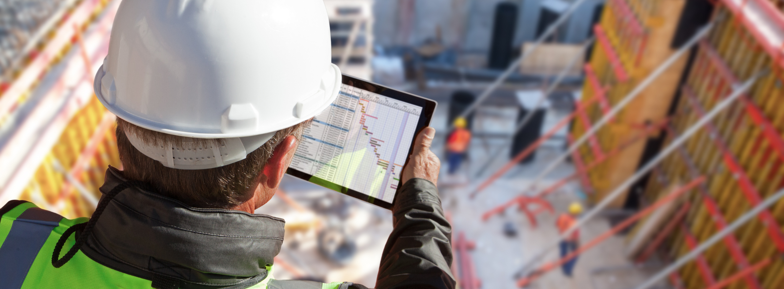 Engineer using a tech, under construction.